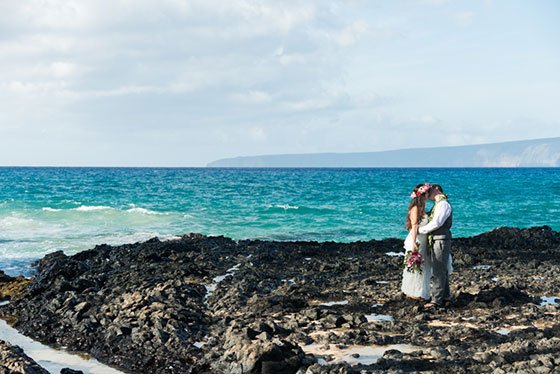 A Maui wedding with a flower circle in the sand at sunset
